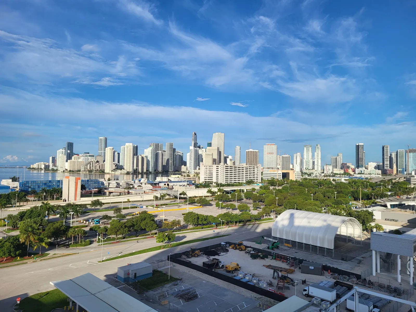 A stunning view of the Miami skyline with clear skies and bustling city life.