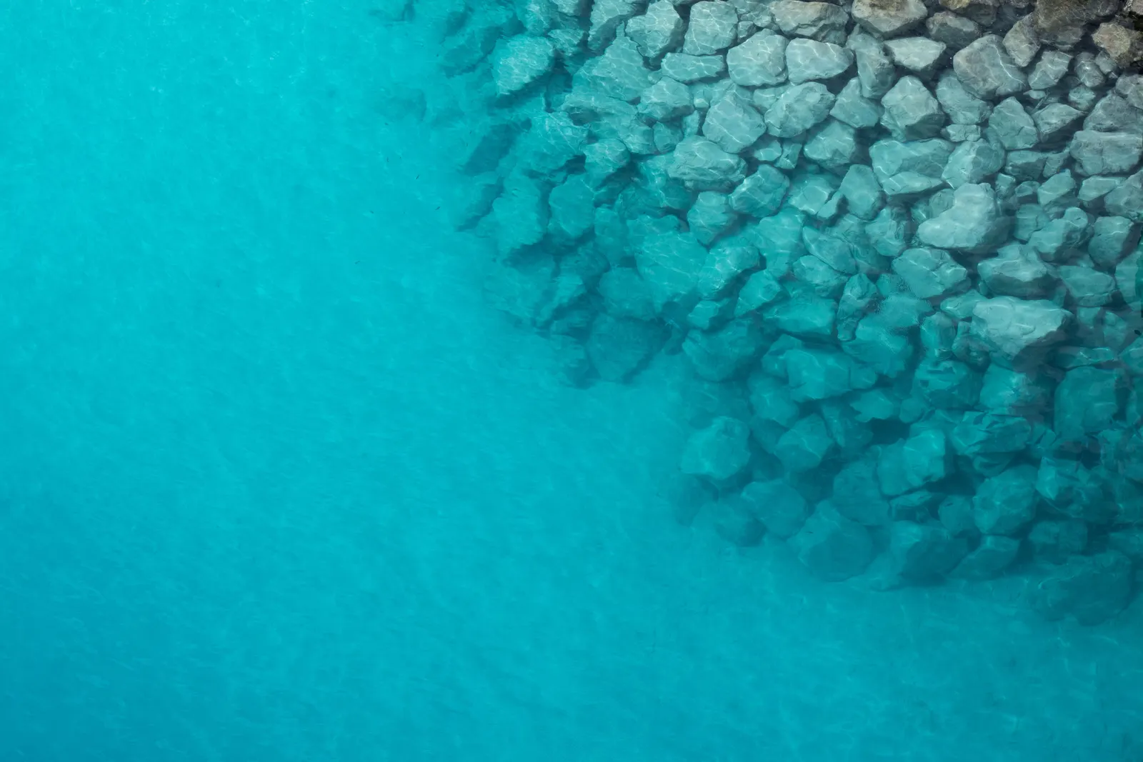 Stunning aerial view of rocky shoreline blending into the clear turquoise waters of Bimini, The Bahamas.