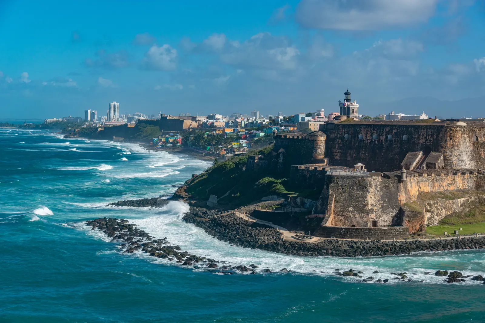 Scenic view of El Morro fortress and vibrant San Juan coastline, Puerto Rico.
